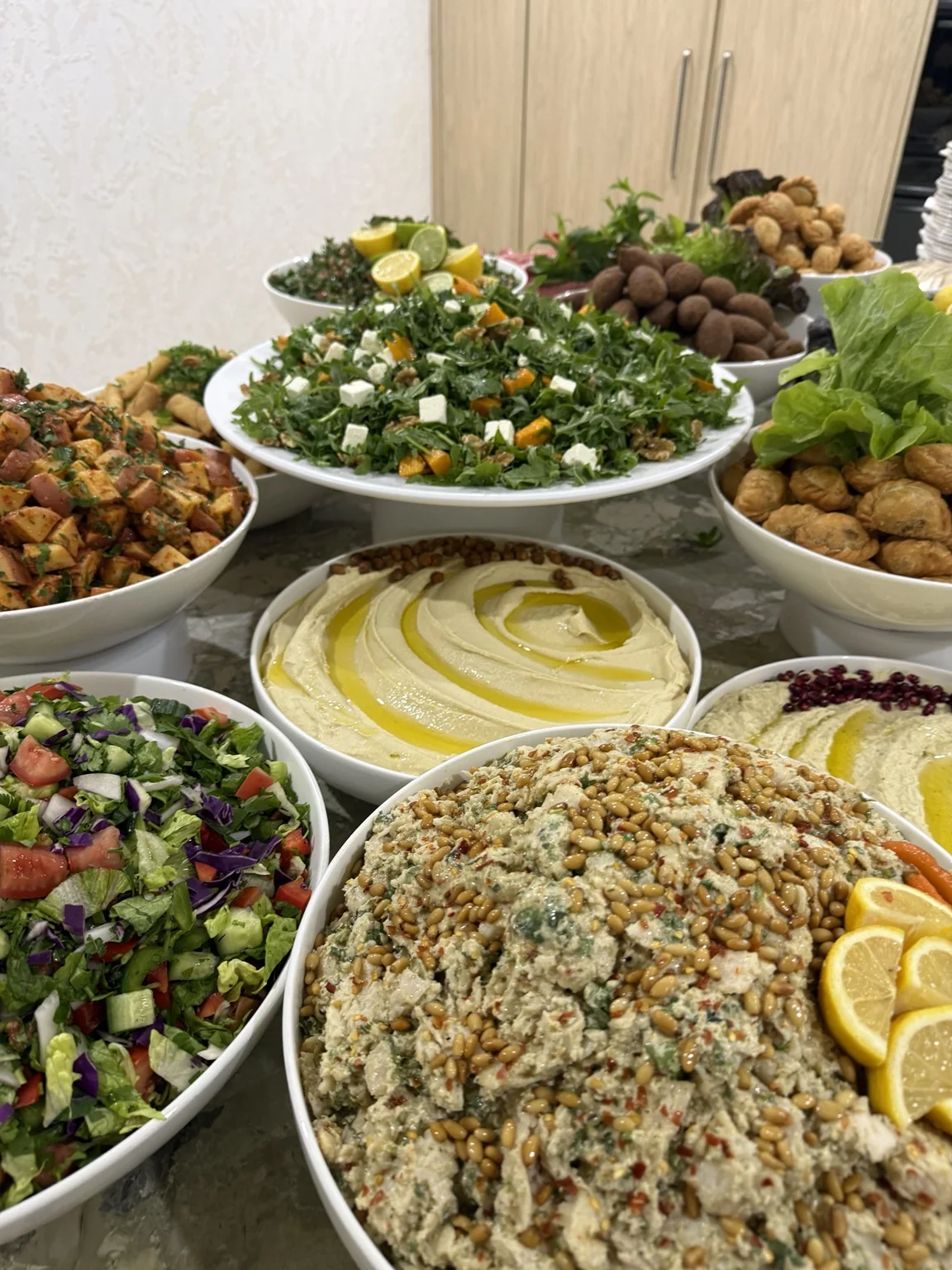 Lebanese salads, dips and rice prepared for a catered event