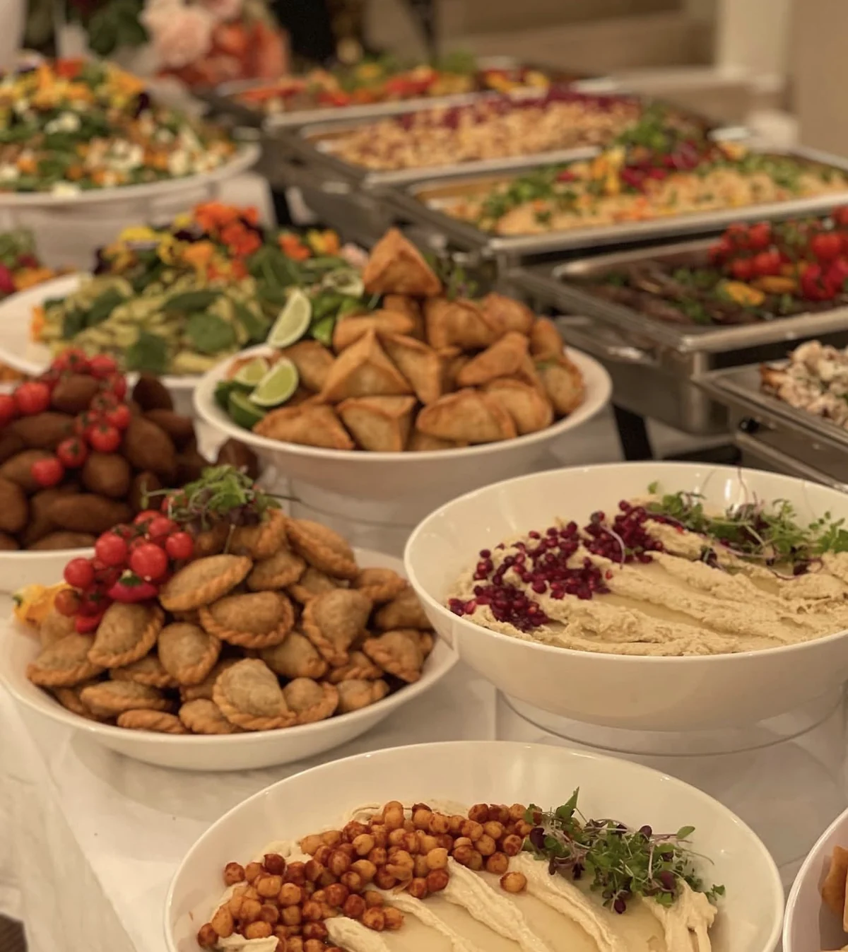 An abundant Lebanese buffet with sambousek, dips and hot dishes