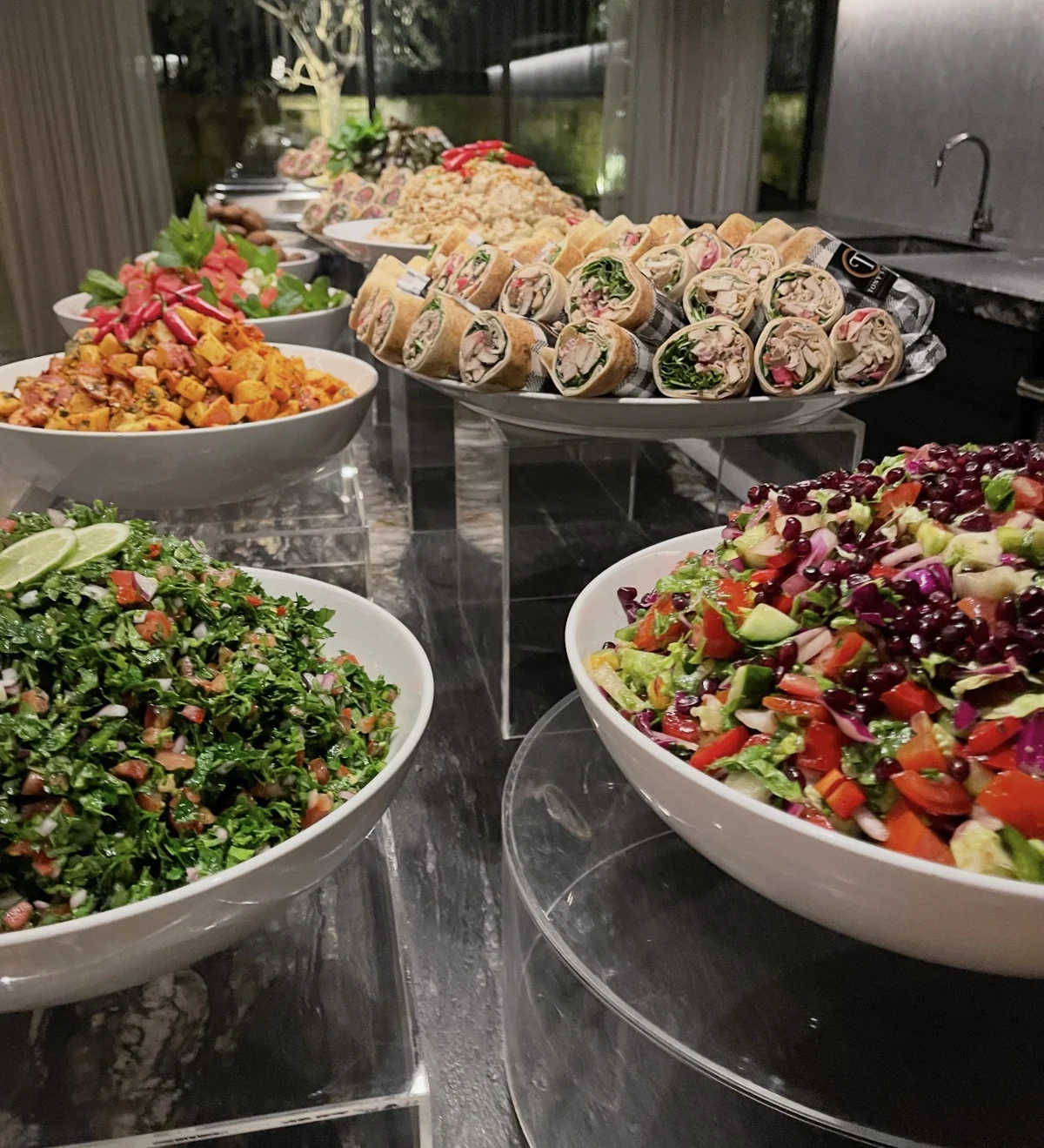 Fresh wraps and colourful salads arranged for a catered event