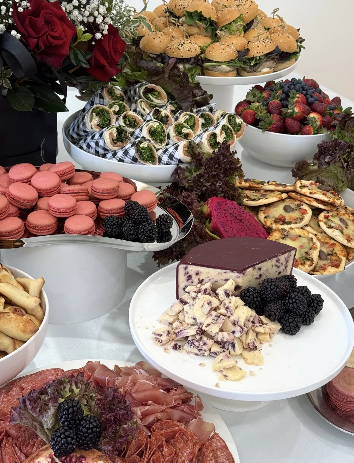 A colourful spread of wraps, sliders, macarons, cheese and charcuterie